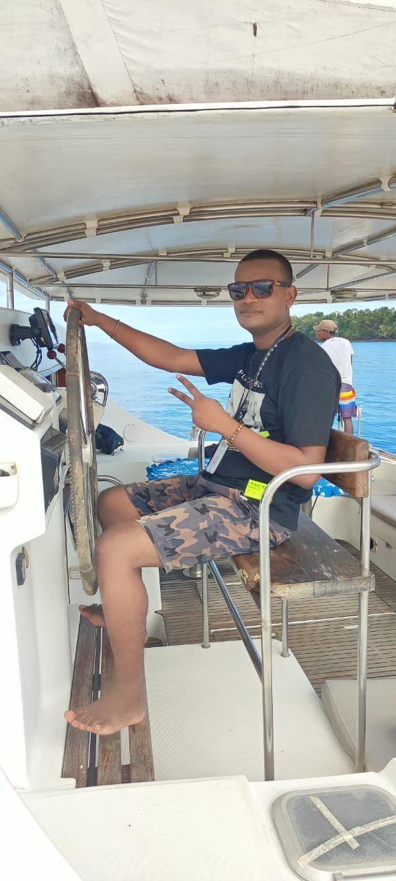 At the helm of the Adventurer catamaran