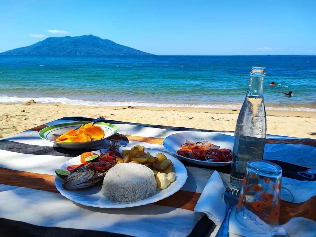 Fresh grilled fish and rice on the beach at Nosy Iranja