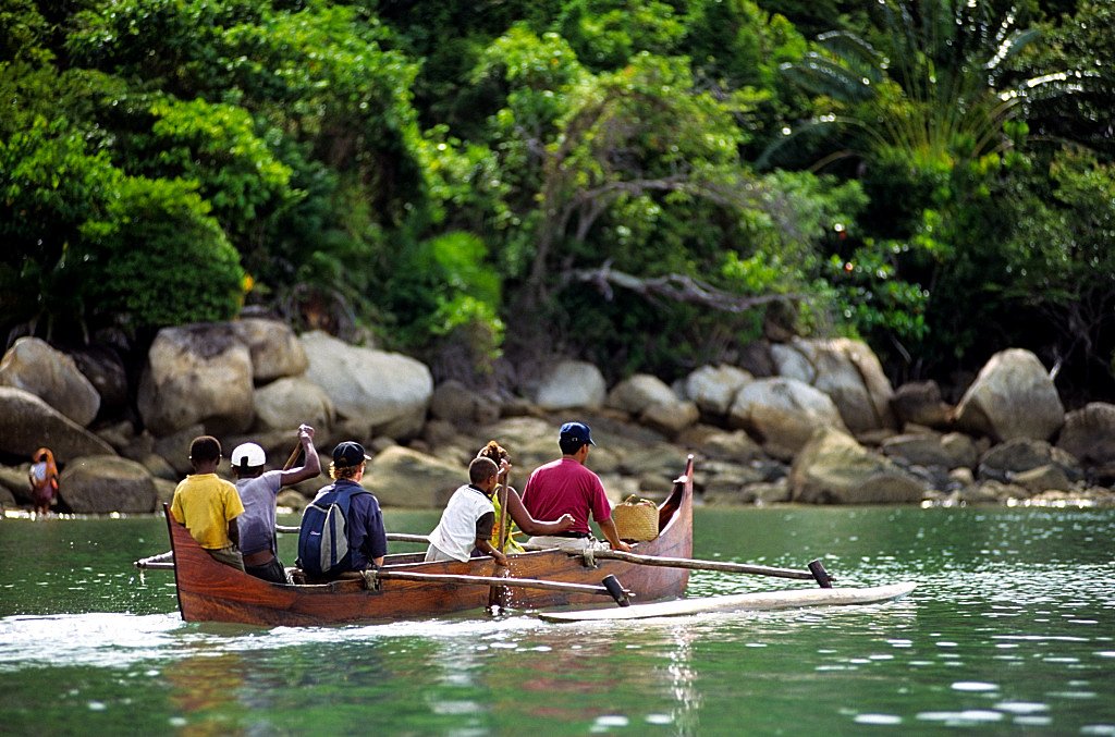 Visitors arriving at Lokobe by traditional wooden outrigger pirogue